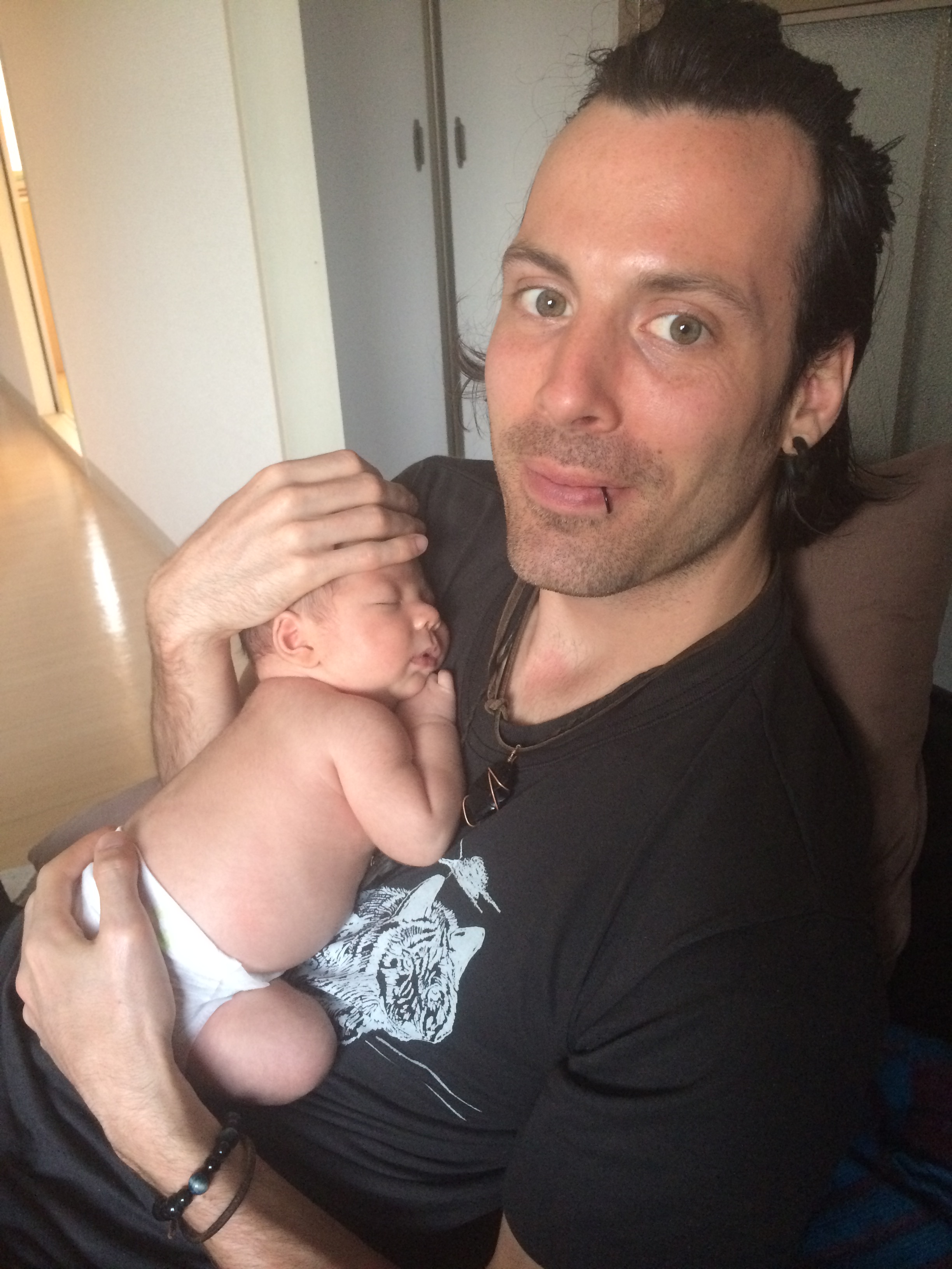 husband holding newborn baby