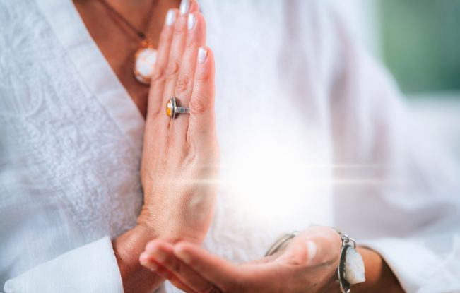 A woman sitting intentionally, getting centered into her purpose. Aligning to meaning
